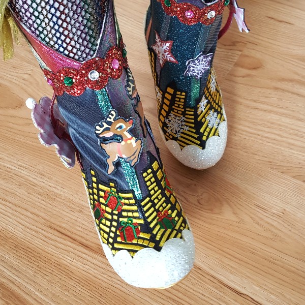 close up of applique and movable character details on ankle boots