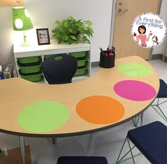 Guided reading table with Wall Pops helps to identify student space and they serve as dry erase boards when used with wipe-off markers. Bins behind the table hold materials needed for each guided reading group