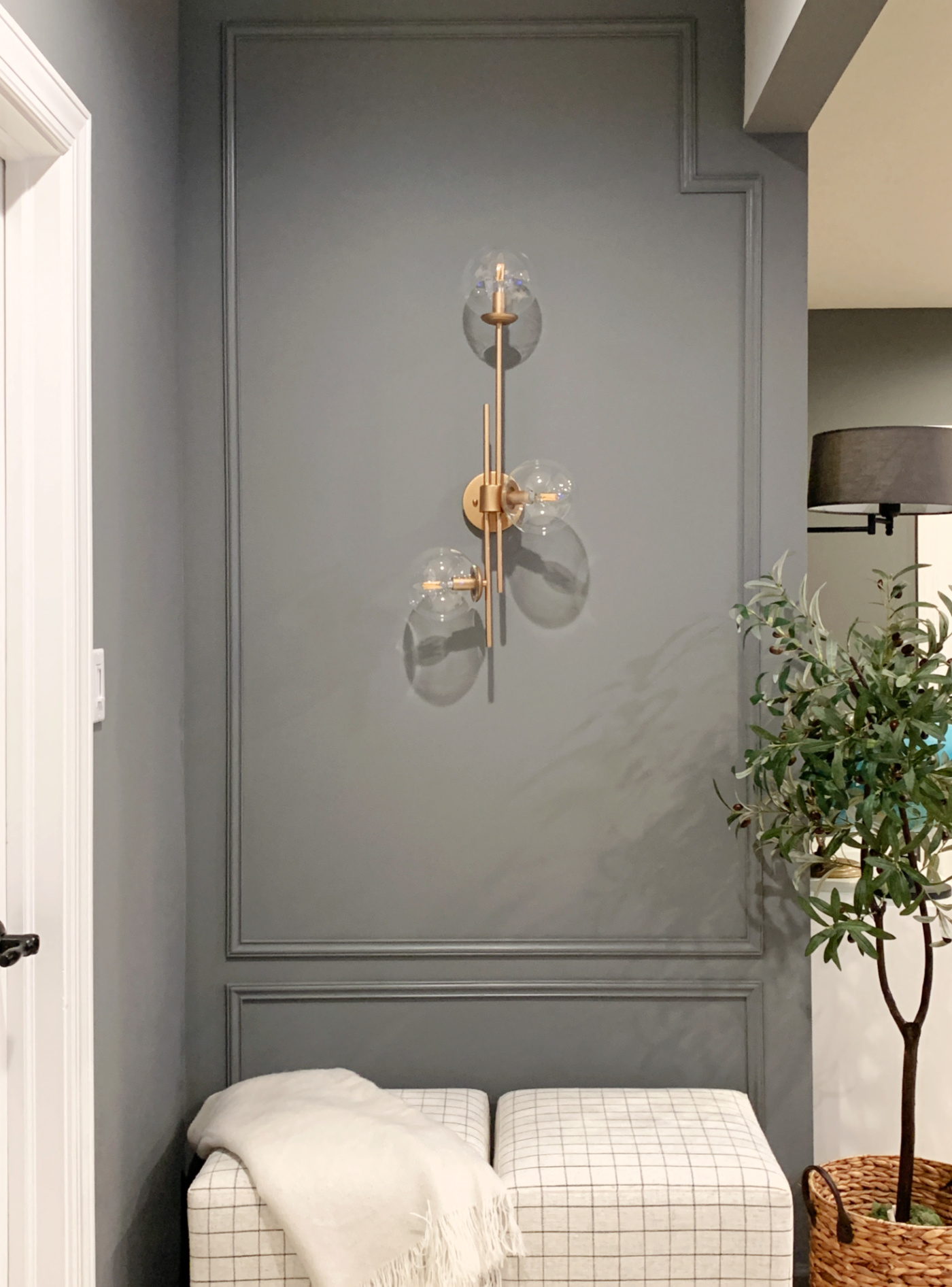Westchester Gray accent wall with brass sconce