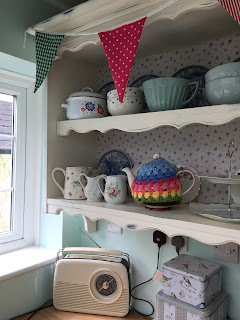 Handmade bunting and crocheted tea cosy