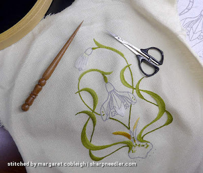 Preparing to remove some embroidery with a laying tool and some scissors
