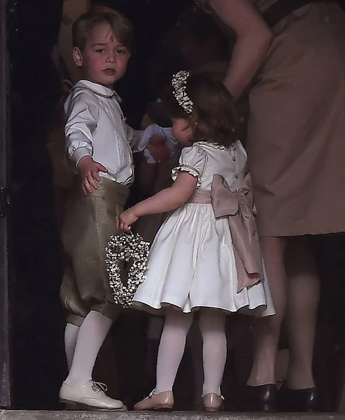 Duchess Catherine, her children Prince George of Cambridge, page boy and Princess Charlotte of Cambridge, flower girl attend the wedding of Pippa Middleton