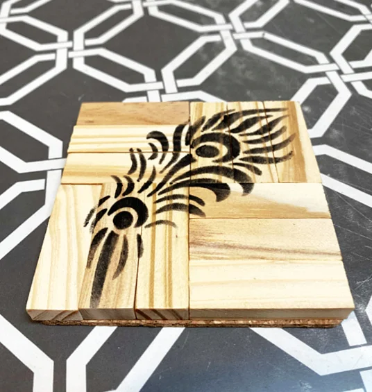 black feather stenciled on coaster