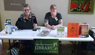 Librarians from timberland set up at a table