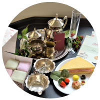 cafe tearoom tuff tray with silver teapot, plastic champagne glass, fondant famcies and macarons