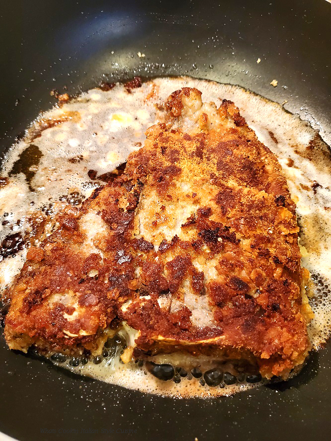 this is a t bone frying in a fry pan in hot canola oil