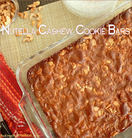 Nutella Cashew Cookie Bars start with a cookie crust, have a cashew center and are baked topped with a gooey Nutella mix. | Recipe developed by www.BakingInATornado.com | #bake #dessert