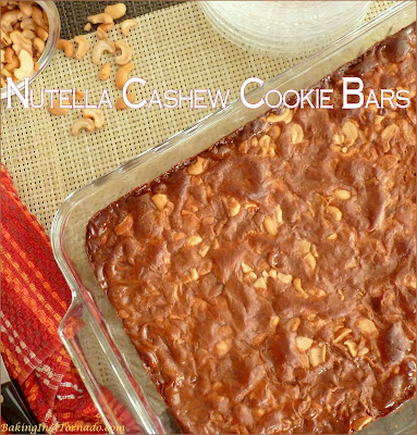 Nutella Cashew Cookie Bars start with a cookie crust, have a cashew center and are baked topped with a gooey Nutella mix. | Recipe developed by www.BakingInATornado.com | #bake #dessert