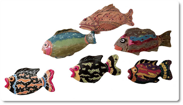 Ceramic art can be grouped together forming one large art form School of fish ceramic art hanging on the wall