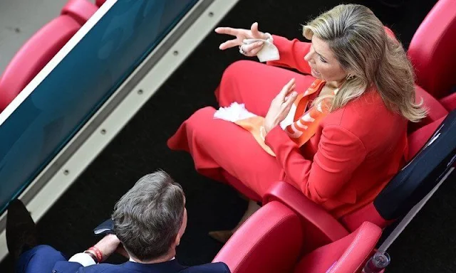 King Willem-Alexander and Queen Maxima attended the UEFA 2020 football match. Massimo Dutti orange suit, Natan, Zara red blazer