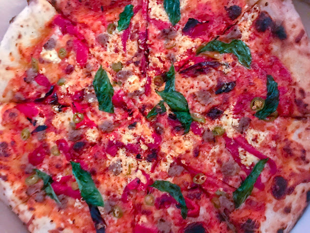 Pizza with sausage peppers and onions. Photo ny Nicole Ruiz Hudson.