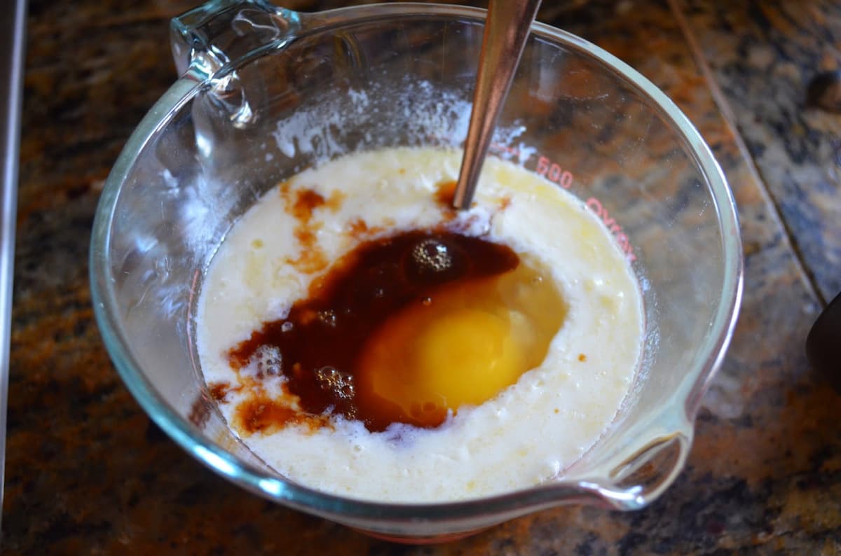 Buttermilk, Melted Butter, Vanilla, and Eggs in a glass measuring cup.