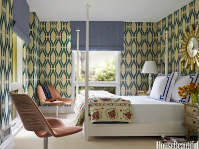 This four poster bed and groovy wallpaper is reminiscent of 60s design.