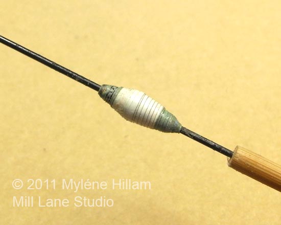 The finished paper bead on the bead rolling tool.
