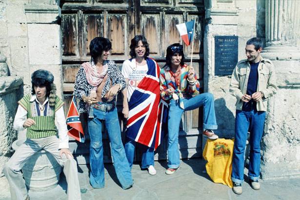 Mick+Jagger+(with+Union+Jack+flag)+and+his+Rolling+Stones+band+stand+at+the+famous+Alamo+in+San+Antionio,+Texas.++Wednesday+4+June+1975