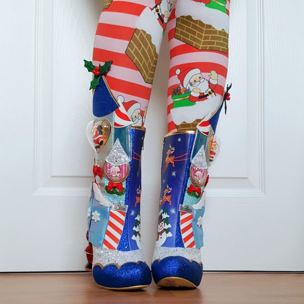 wearing blue glitter Christmas boots with Santa figure and striped turrets