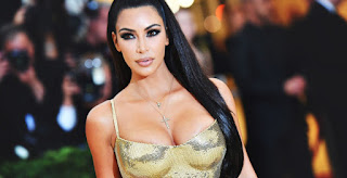 kim kardashian at met gala in shiny gold dress wearing strapless bra