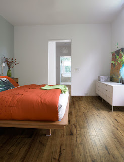 Cork flooring in bedroom with orange large bed