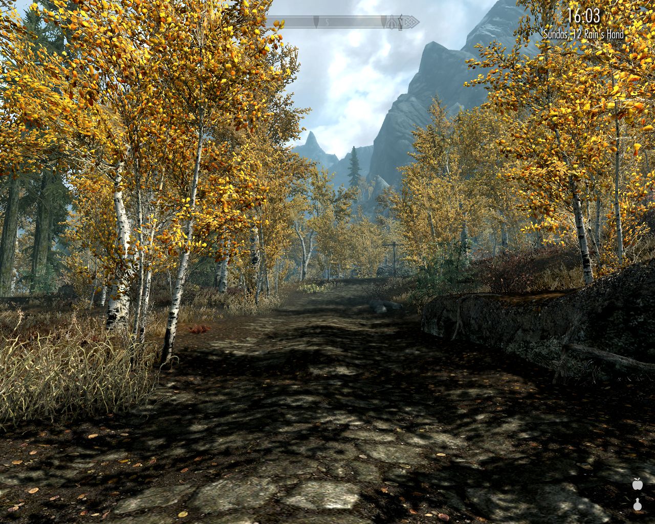 paved road, birch forest on both sides, high mountains in the distance, partially cloudy sky