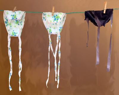 3 face masks drying on clothesline