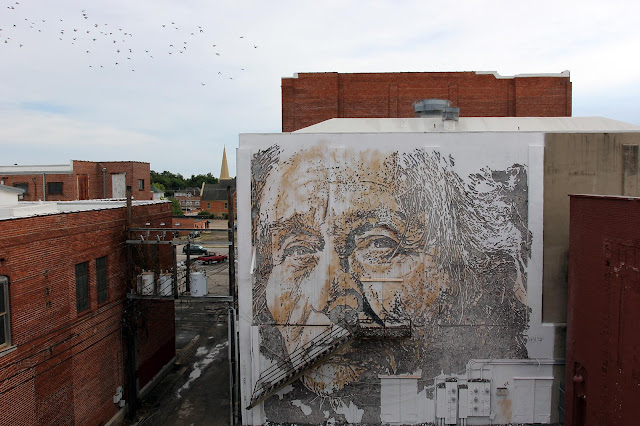 Vhils is the second artist to complete his mural in Downtown Fort Smith for the first edition of the excellent Unexpected Street Art Festival which is curated by JustKids.