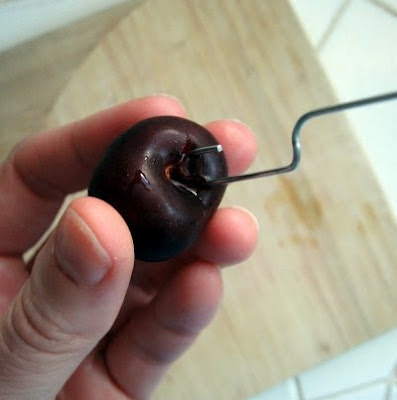 pitting a cherry with a paper clip