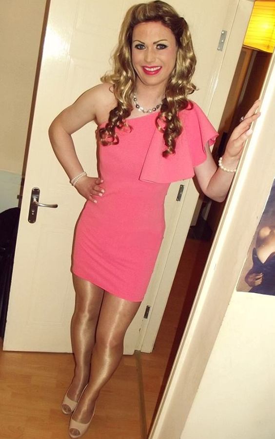 A beautiful crrossdresser looking gorgeous in her pink dress, shiny pantyhose and high heels