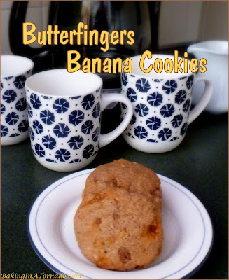 Butterfingers Banana Cookies are a soft cookie with a surprise crunch inside. Banana and crunchy peanut butter batter is studded with butterfingers pieces for a delicious flavor pairing. | Recipe developed by www.BakingInATornado.com | #recipe #cookies