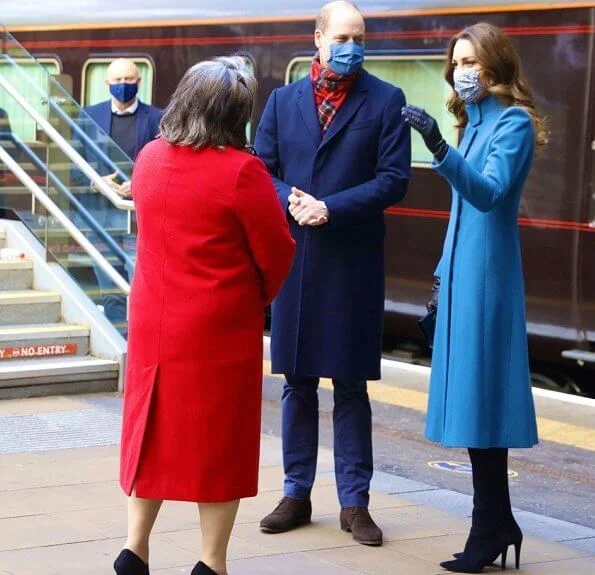 Kate Middleton wore a khaki coat and tartan scarf from Alexander McQueen, and blue coat and black gloves from Catherine Walker. Meghan Markle