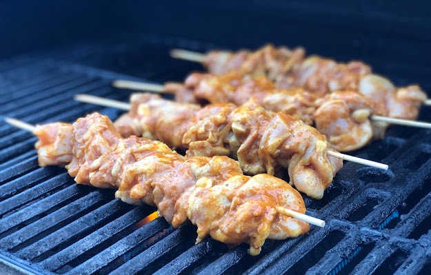 Marinated chicken skewers on grill