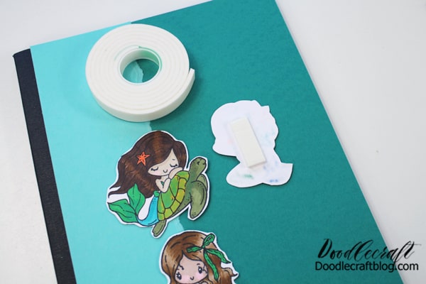 Add foam tape on the back of the little TGF Mermaids and stick them to the notebook.