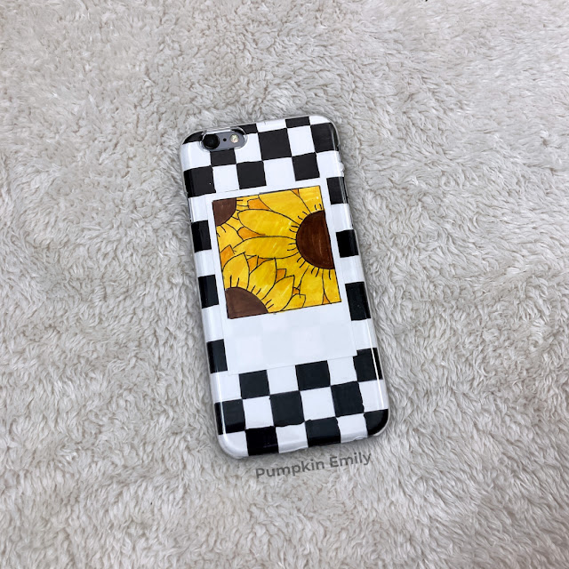 DIY phone case with a black and white grid and with a polaroid on top.