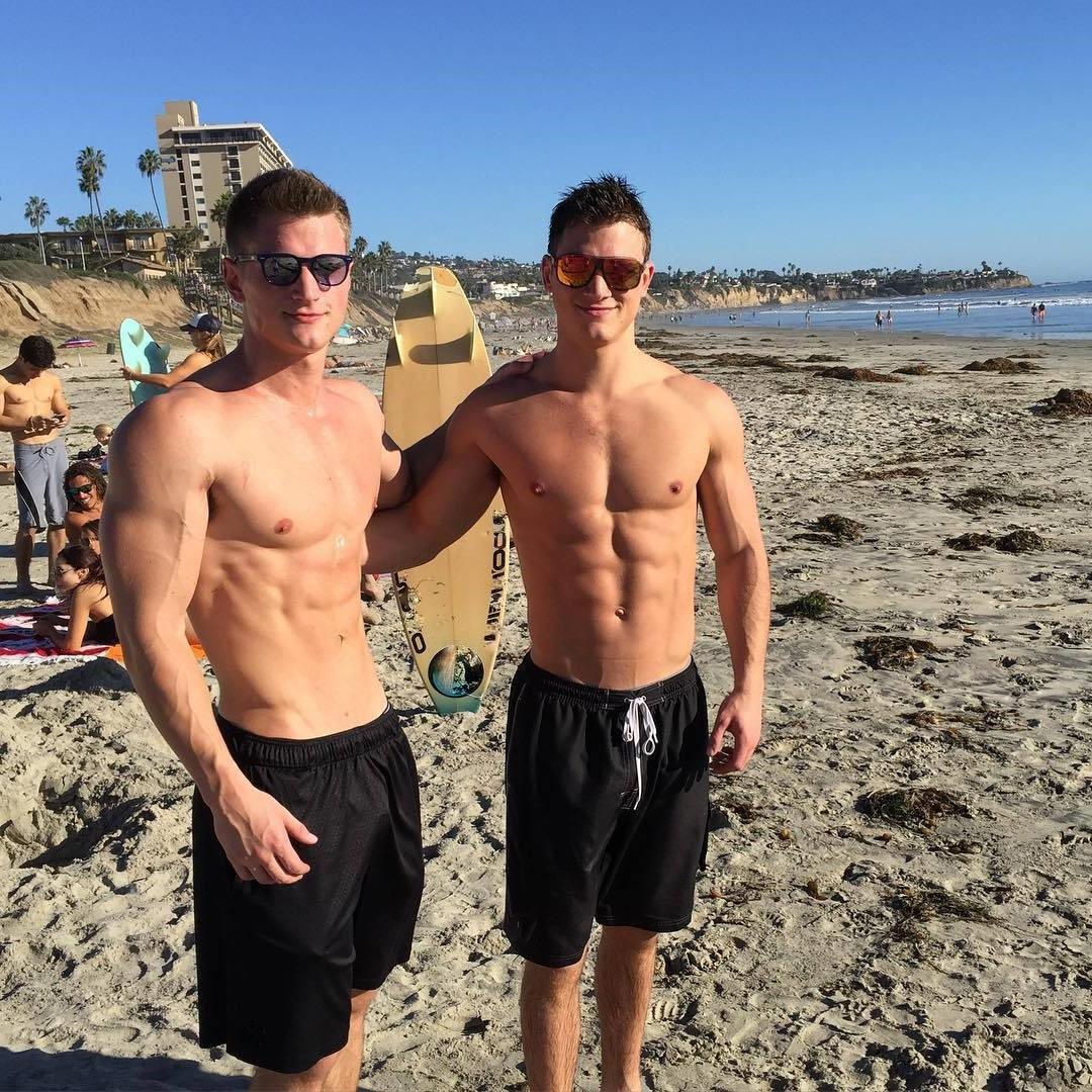 two-sexy-bros-enjoying-sandy-beach-day-sunglasses-shirtless-fit-bodies