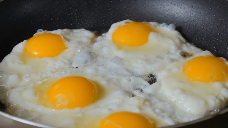 Egg cooking on pan. healthy high protein food