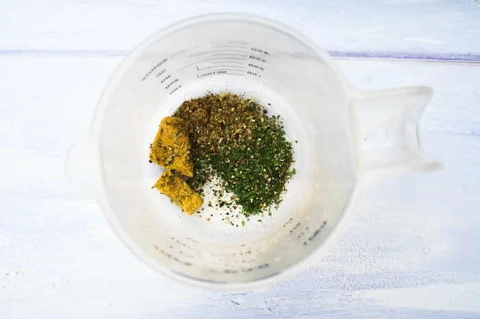 rice flavourings in measuring jug (vegetable stock cube, dried herbs, salt and pepper)