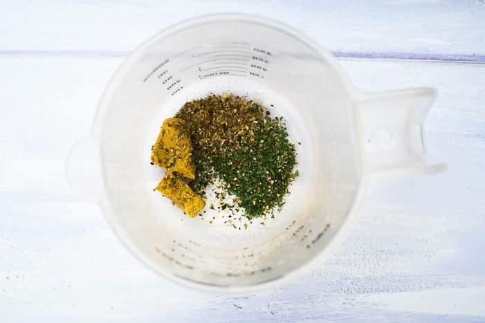 rice flavourings in measuring jug (vegetable stock cube, dried herbs, salt and pepper)