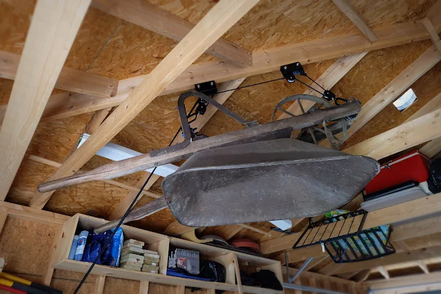 using kayak hoist to store wheelbarrow high up in garage
