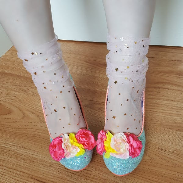 wearing star tulle socks with glitter shoes with bright flowers on front