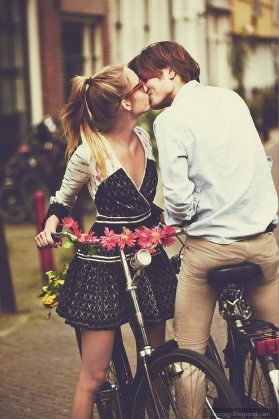 Kissing cute couple on bicycle lovers romantic deep affection