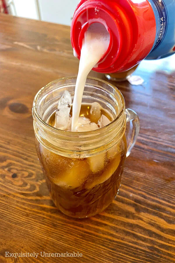 Adding Creamer To Ice Coffee