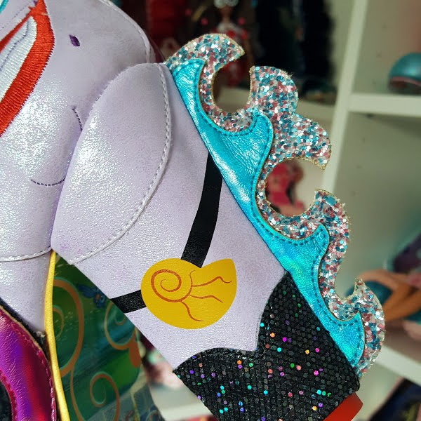 close up of Ursula Disney heel with metallic and glitter wave design at heel