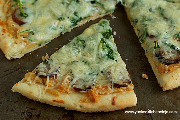 smoked sausage pizza with arugula and caramelized onion-goat cheese sauce
