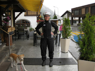 Aranka and pep in her rain gear outside a café in Trun, Switzerland.