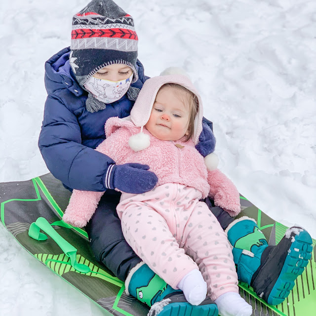 Brother and sister sledding