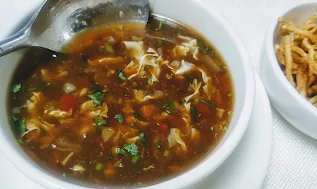 Serving chicken manchow soup with fried noodles for chicken manchow soup recipe