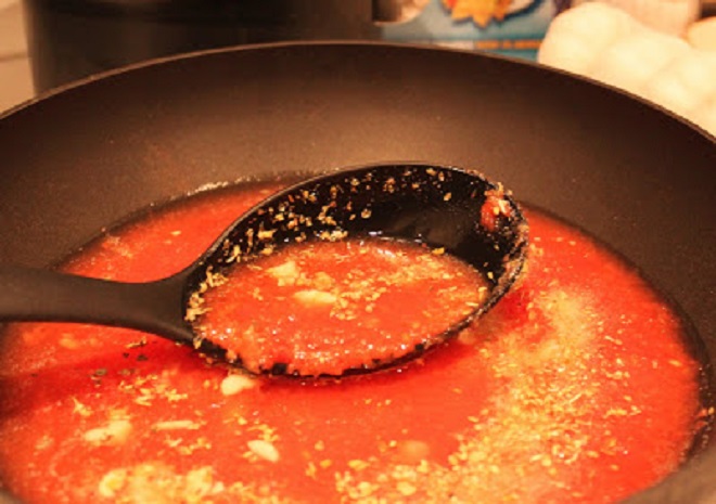 marinara is a quick sauce in a pan with a ladle showing the fresh plum tomato pureed