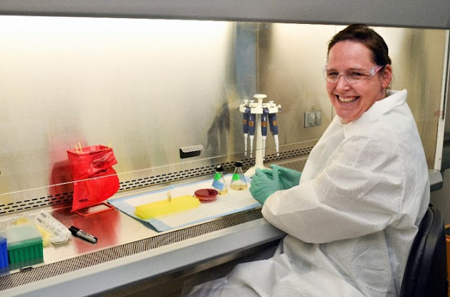 Dr. Riner sitting at a lab table 