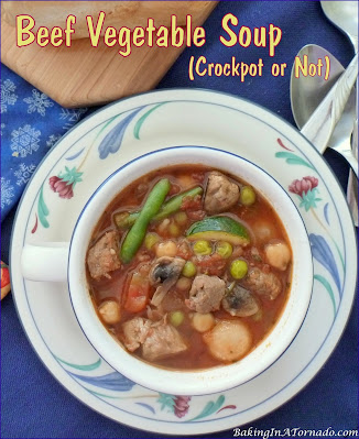 Beef Vegetable Soup is a hearty dinner made either in a slow cooker or on the stove top. Lean stew beef is slow cooked, add beans, vegetables, and rice for a one bowl full meal. | Recipe developed by www.BakingInATornado.com | #recipe #dinner