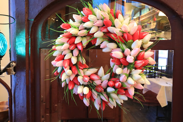 Photo of a flower wreath hanging on a door