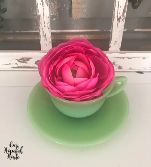 jadeite tea cup causer pink ranunculus stem
